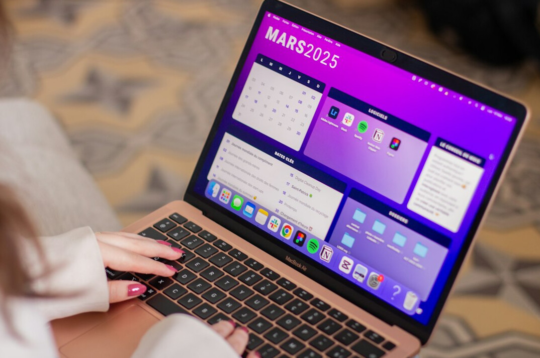 Close-up of hands typing code on a laptop keyboard